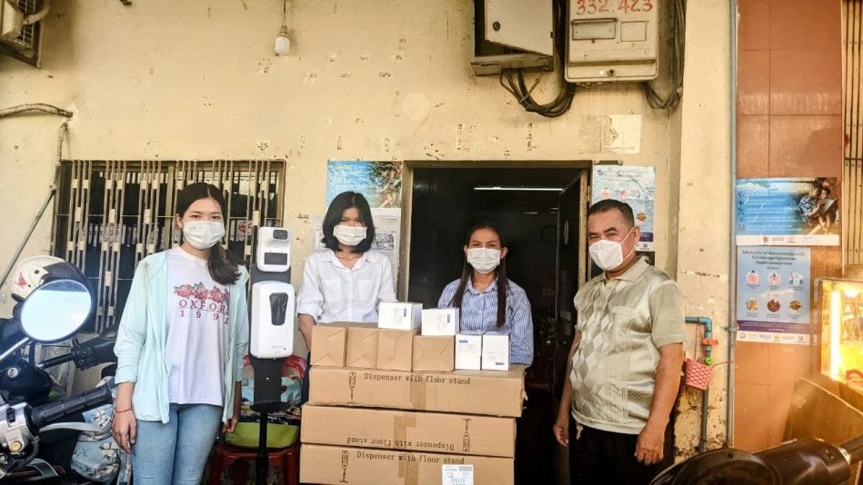 Giving out hand sanitizer and Hand washing message to local market authorities.Research study on affordable housing in Cambodia